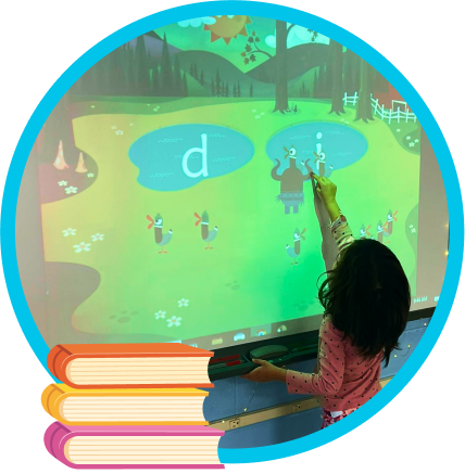 A child plays Teach Your Monster to Read on a school white board.