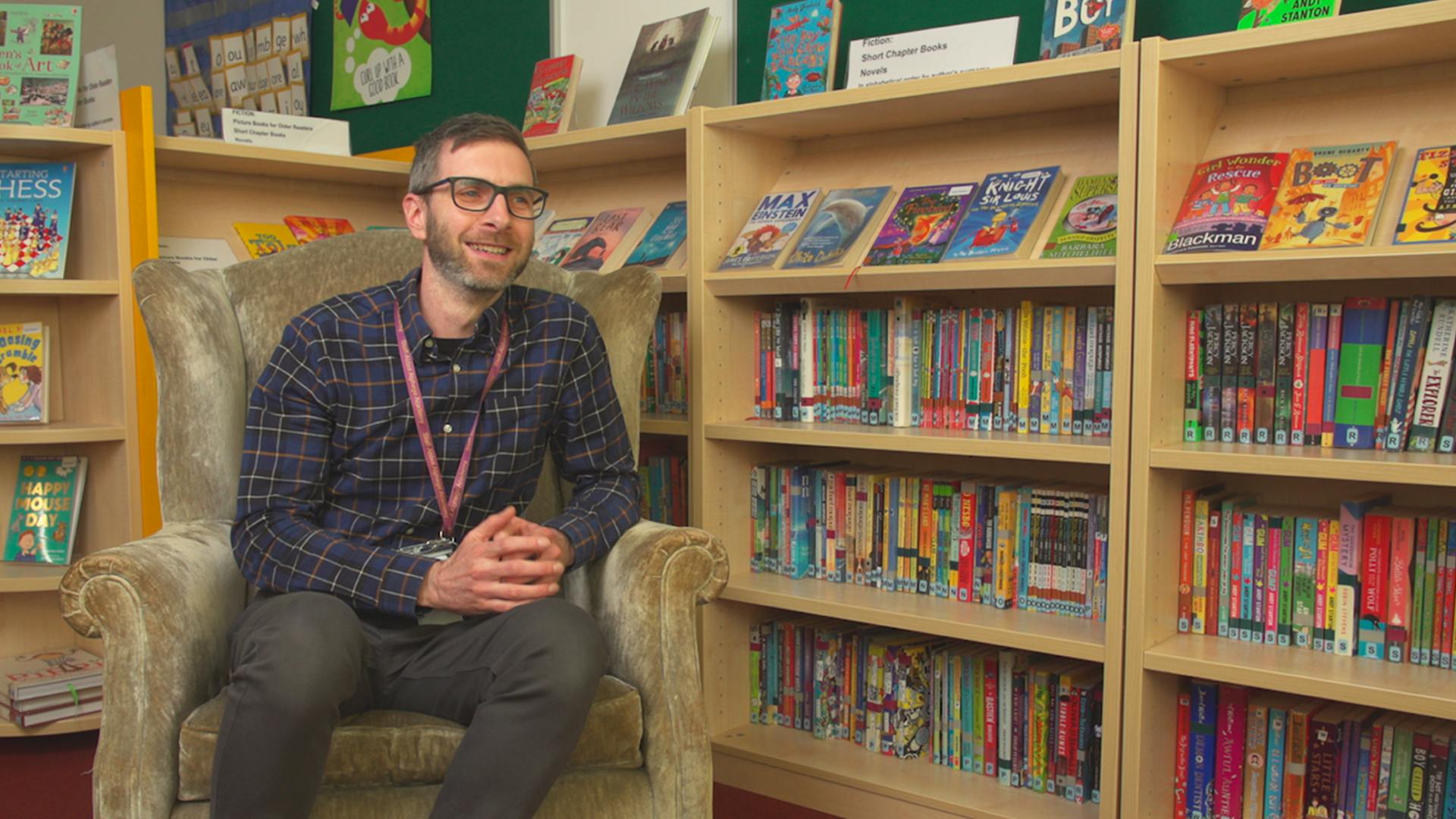 Teacher Adam Samuel in the school library