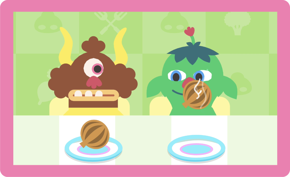 Two monsters sit at a table with plates in front of them. One is smelling an onion.
