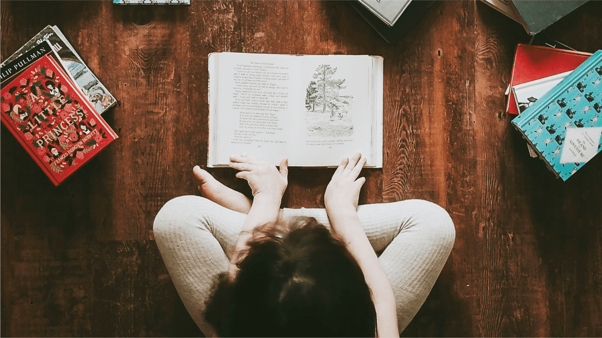 A top down view of a child reading a story book