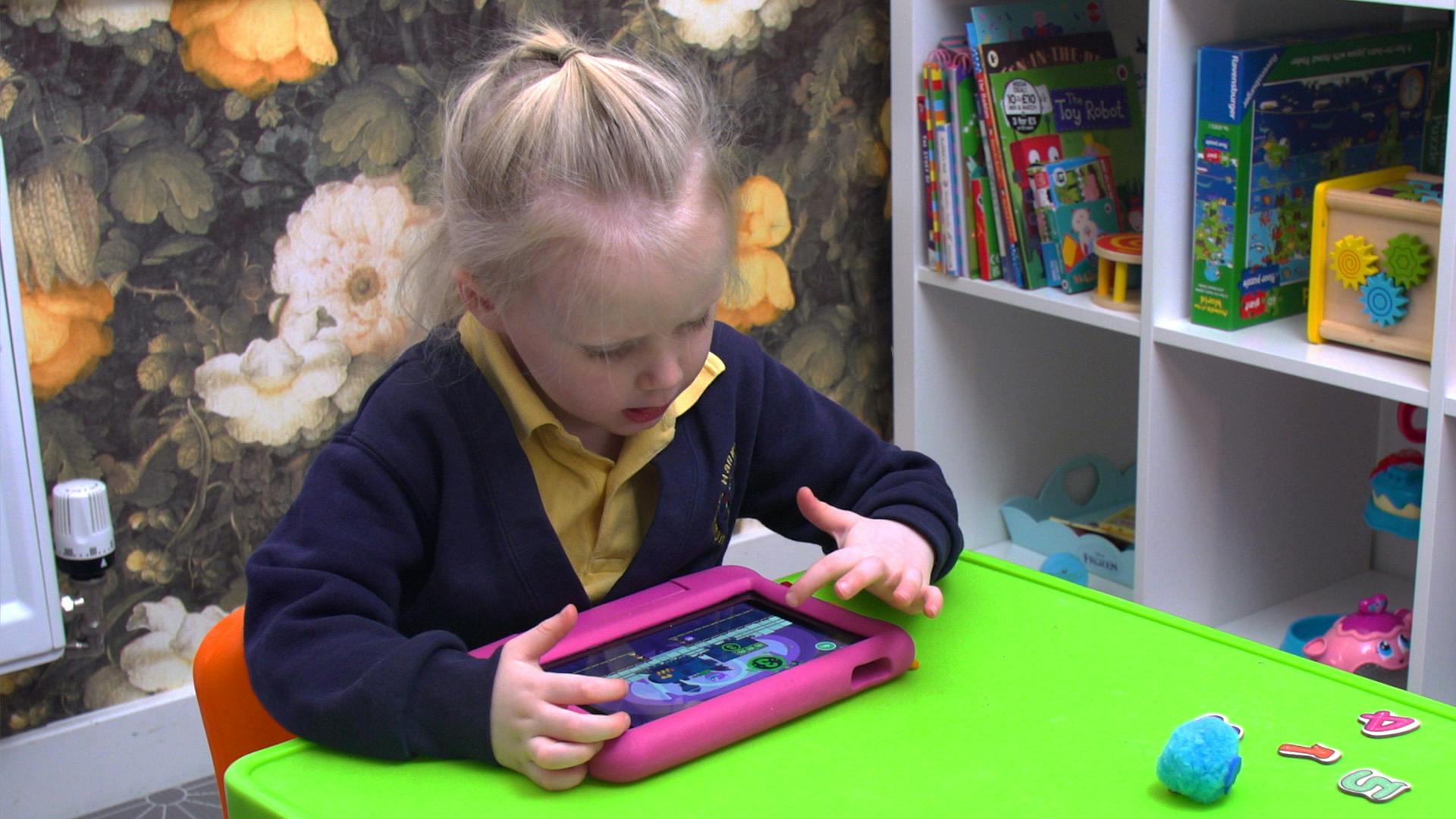 A young girl playing Number Skills on an iPad