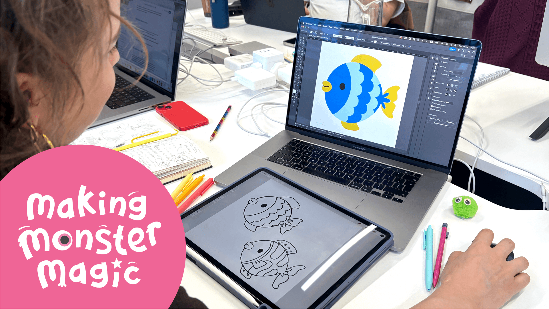 A woman working on a fish image on a laptop