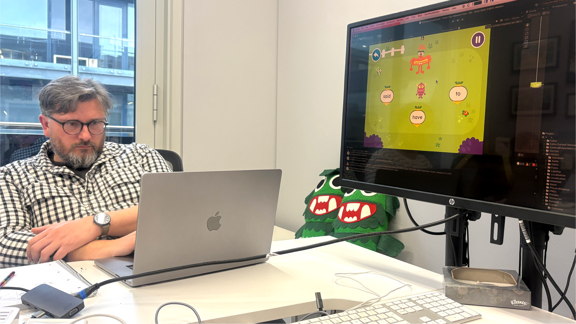 A game developer working with a screen